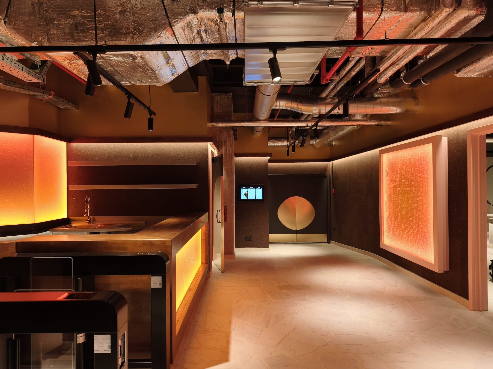 Bar d’accueil : comptoir en bois, panneaux rétroéclairés, plafond technique